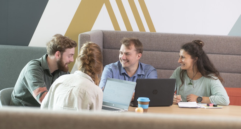 mature students sitting around a computer