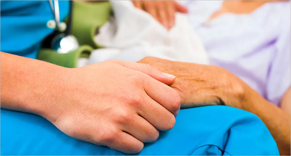 Nurse holding the hand of a patient