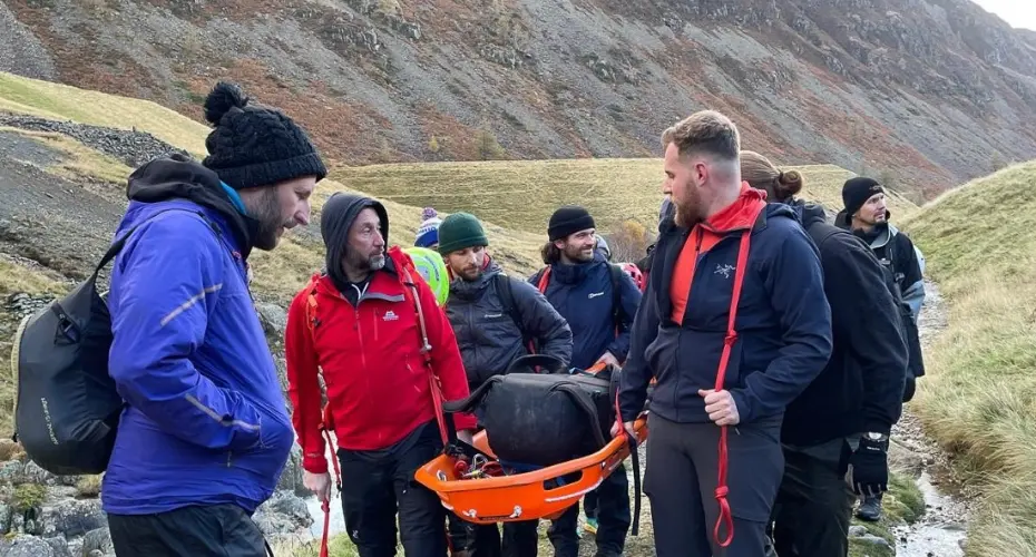 Extreme Medicine students on a Search and Rescue residential in the UK. They are carrying a backpack on a stretcher in the mountains to simulate a patient rescue mission