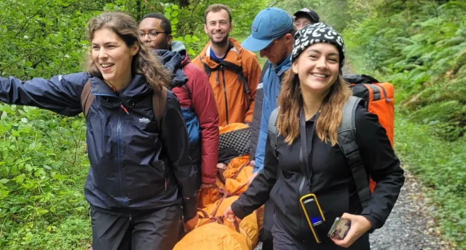 Group of Extreme Medicine students carrying a dummy patient on an exercise