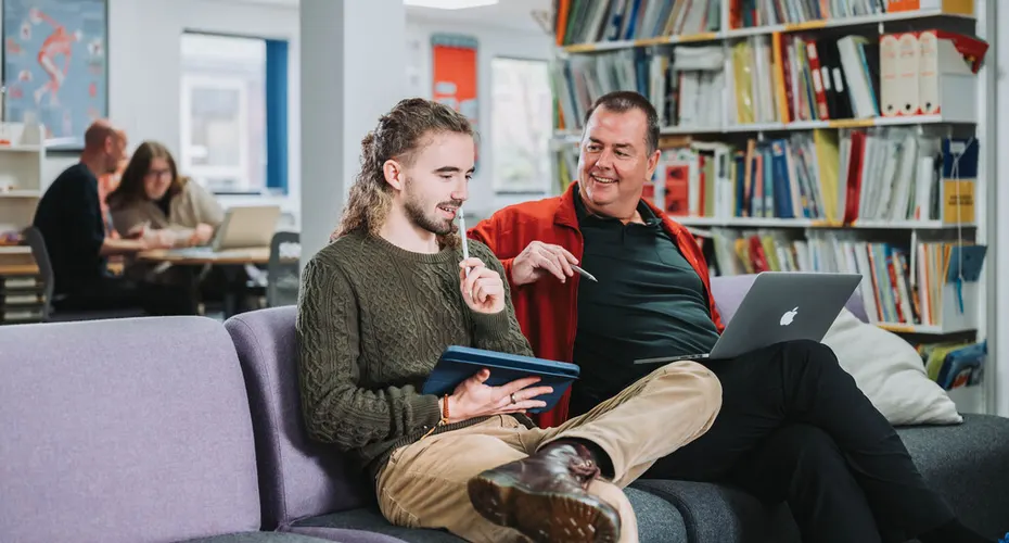 PGCE students having a discussion in the communal / study area in Baring Court, St Luke's Campus.