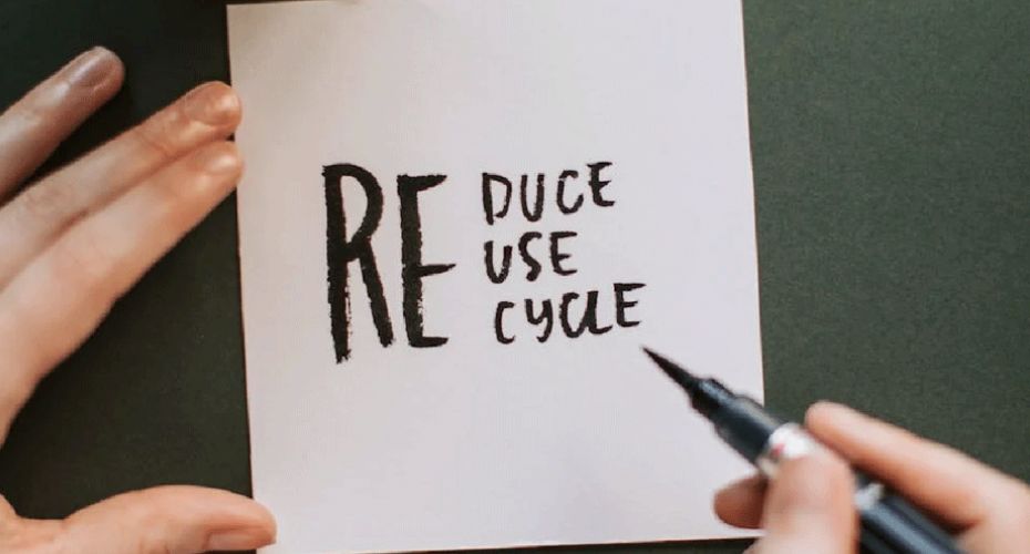 notepad with 'reduce reuse recycle' written on it