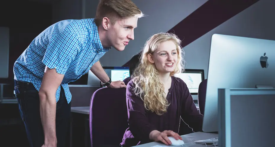 Students sat working at a computer.