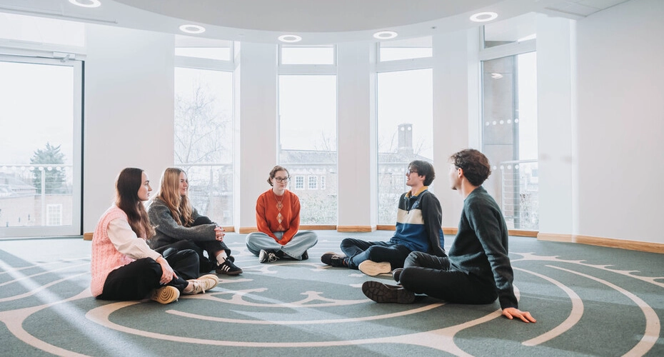 Some students sitting on the floor of the multifaith centre.