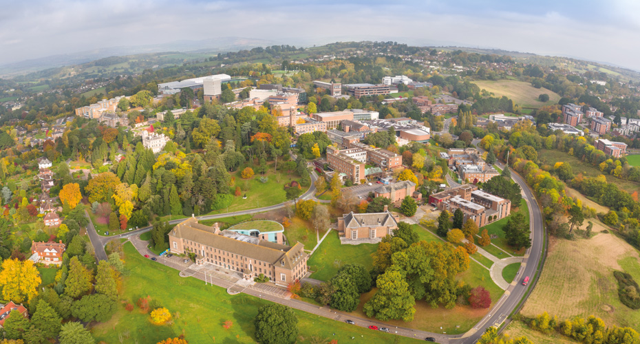 Aerial view of streatham campus in exeter, showcasing vibrant fall foliage across the college grounds.